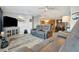 Inviting living room with modern furnishings, neutral paint, wood flooring, and seamless flow to dining area at 109 W Saint Lucia Loop, Apollo Beach, FL 33572