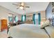 Bright bedroom featuring wood flooring, neutral walls, and a mirrored closet at 109 W Saint Lucia Loop, Apollo Beach, FL 33572