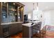 Wet bar with open shelves, wine fridge, and waterfall countertop at 11105 5Th E St, Treasure Island, FL 33706