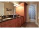 Bathroom with double sinks, granite countertops, hardwood floors, and an adjoining shower/toilet room at 11105 5Th E St, Treasure Island, FL 33706