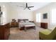 Spacious bedroom with neutral carpet, ceiling fan, and decorative furnishings at 11105 5Th E St, Treasure Island, FL 33706