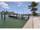 Dock with boat lift offers direct access to waterfront living at 11105 5Th E St, Treasure Island, FL 33706