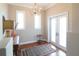 Inviting entryway boasts a decorative rug, beautiful hardwood floors, and a stylish chandelier at 11105 5Th E St, Treasure Island, FL 33706