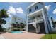 This two-story home features a pool, a unique spiral staircase, and a charming blue exterior at 11105 5Th E St, Treasure Island, FL 33706