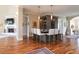 Open concept living room with a fireplace, bar area, hardwood floors, and stylish furnishings at 11105 5Th E St, Treasure Island, FL 33706