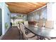 Covered patio with an elegant dining setup and a glimpse of the scenic waterfront at 11105 5Th E St, Treasure Island, FL 33706