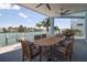 This patio features a wooden dining table and overlooks the water at 11105 5Th E St, Treasure Island, FL 33706