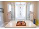 Walk-in shower featuring glass doors and white tile at 11105 5Th E St, Treasure Island, FL 33706