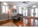 Sitting room boasts hardwood floors, plantation shutters, ceiling fan and comfortable furnishings at 11105 5Th E St, Treasure Island, FL 33706