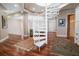 Open loft area with a white spiral staircase, wood floors and a view of the living space at 11105 5Th E St, Treasure Island, FL 33706