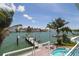 Stunning waterfront view from the balcony, with a private dock and lush palm trees at 11105 5Th E St, Treasure Island, FL 33706