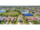 Beautiful aerial view of a suburban home with a pond and lush green landscaping at 11414 Weston Course Loop, Riverview, FL 33579