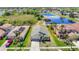 A lovely suburban home boasts a well-manicured lawn and landscaping alongside a tranquil pond at 11414 Weston Course Loop, Riverview, FL 33579