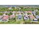 A beautiful aerial view shows the neighborhood homes, and a lake in the background on a sunny day at 11414 Weston Course Loop, Riverview, FL 33579