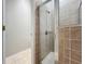 Bathroom featuring a glass shower door and neutral toned tile throughout the shower at 11414 Weston Course Loop, Riverview, FL 33579