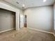 Neutral carpeted bedroom featuring an open closet and doorway at 11414 Weston Course Loop, Riverview, FL 33579