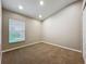 Cozy carpeted bedroom with a large window and ample natural light at 11414 Weston Course Loop, Riverview, FL 33579