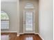 Light filled entryway with hardwood floors, transom window over the door, and neutral walls at 11414 Weston Course Loop, Riverview, FL 33579