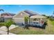 Well-maintained single-Gathering home featuring a two-car garage, arched entryway, and manicured lawn at 11414 Weston Course Loop, Riverview, FL 33579