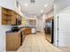 Well-lit kitchen features modern appliances, tile flooring, and ample cabinet space at 11414 Weston Course Loop, Riverview, FL 33579