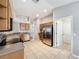 Spacious kitchen with tile floor, stainless steel appliances, wooden cabinets, and ample counter space at 11414 Weston Course Loop, Riverview, FL 33579