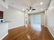 Open living room with wood floors, ceiling fan, and sliding glass door for natural light at 11414 Weston Course Loop, Riverview, FL 33579
