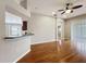 Hardwood floors in an open-concept living area with breakfast bar and large sliding glass door at 11414 Weston Course Loop, Riverview, FL 33579