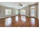 Bright living room featuring hardwood floors, a ceiling fan, and lots of natural light at 11414 Weston Course Loop, Riverview, FL 33579