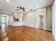 Spacious living room with hardwood floors and a ceiling fan, adjacent to the kitchen at 11414 Weston Course Loop, Riverview, FL 33579