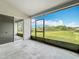 Enclosed patio with sliding door and scenic views of the green backyard and pond at 11414 Weston Course Loop, Riverview, FL 33579