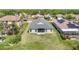 Rear view of a well-maintained home with a spacious lawn and screened in patio at 11414 Weston Course Loop, Riverview, FL 33579