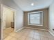 Tiled room featuring a utility sink, modern stacked washer dryer, and window with blinds at 11414 Weston Course Loop, Riverview, FL 33579