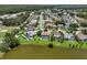 An aerial view of lakeside community homes, featuring fenced yards, sparkling pools, and lush landscaping at 11519 Glenmont Dr, Tampa, FL 33635