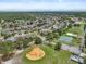 Aerial view showcases the community's amenities, including basketball court and baseball diamond, amid homes at 11519 Glenmont Dr, Tampa, FL 33635