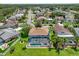 Aerial view of the home with a large pool area and a lake nearby, surrounded by mature trees and well-manicured lawns at 11519 Glenmont Dr, Tampa, FL 33635