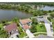 Aerial view of the home with a large lake in the background, surrounded by mature trees and well-maintained landscaping at 11519 Glenmont Dr, Tampa, FL 33635