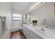 Bathroom features a double sink, vanity, large mirror, and shower-tub combination at 11519 Glenmont Dr, Tampa, FL 33635