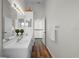 Bathroom boasts double sinks, a large mirror, vanity, and modern wood floors at 11519 Glenmont Dr, Tampa, FL 33635