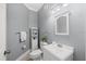 Cozy bathroom featuring a modern vanity, stylish mirror and toilet at 11519 Glenmont Dr, Tampa, FL 33635