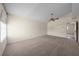 A carpeted bedroom is spacious with a fan, vaulted ceiling, and natural light through the window at 11519 Glenmont Dr, Tampa, FL 33635