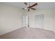 This carpeted bedroom has an attached door to the upper level and a double closet at 11519 Glenmont Dr, Tampa, FL 33635