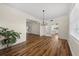 Open-concept dining room with wood floors, chandelier, and easy access to kitchen at 11519 Glenmont Dr, Tampa, FL 33635