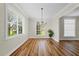 Bright dining room with wood floors, chandelier, and large windows at 11519 Glenmont Dr, Tampa, FL 33635