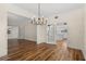 Dining room featuring wood floors, chandelier lighting, and views into the kitchen at 11519 Glenmont Dr, Tampa, FL 33635
