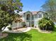 Beautiful two-story home with lush landscaping, a walkway, and well-manicured lawn at 11519 Glenmont Dr, Tampa, FL 33635
