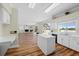 Charming kitchen with island and sleek appliances, seamlessly connecting to the living room with a fireplace at 11519 Glenmont Dr, Tampa, FL 33635