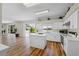 Well-lit kitchen featuring an island, stainless steel appliances, and open access to the living room and lanai at 11519 Glenmont Dr, Tampa, FL 33635