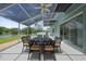 Covered outdoor patio features a table for eight with a view of the swimming pool and lake at 11519 Glenmont Dr, Tampa, FL 33635