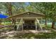 Shaded picnic area with multiple tables and benches, offering a cool and relaxing spot for outdoor gatherings at 11519 Glenmont Dr, Tampa, FL 33635