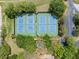 Aerial view of the community tennis courts, surrounded by lush greenery and a parking lot at 11519 Glenmont Dr, Tampa, FL 33635
